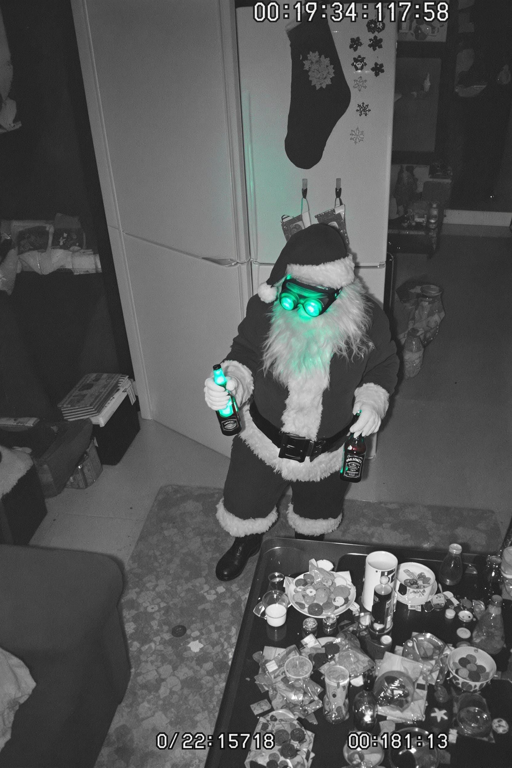 A Dark Grainy Security Camera Footage Photo Of Santa Claus Wearing Night Vision Googles