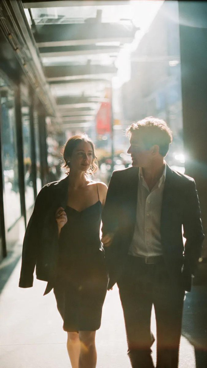 FLUX prompt: A cinematic candid medium shot portrait of a man and a woman walking side by sid...