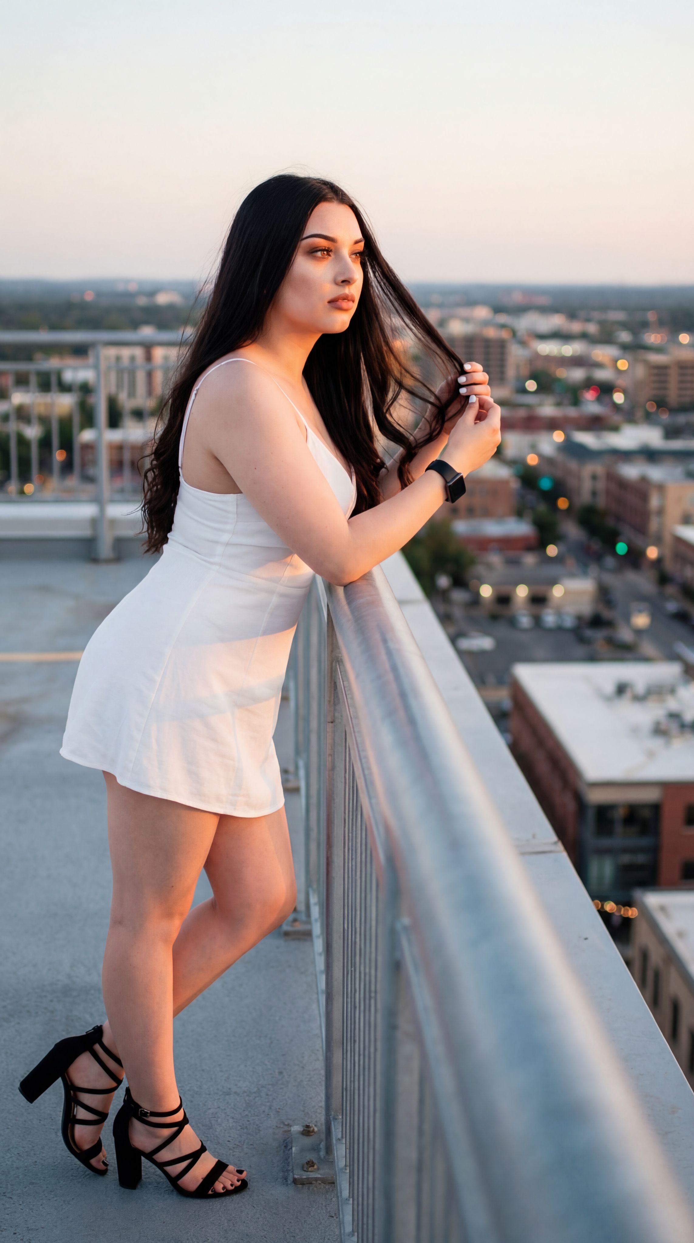 Nano Banana prompt: On a quiet rooftop at golden hour, with the sprawling cityscape twinkling below,...